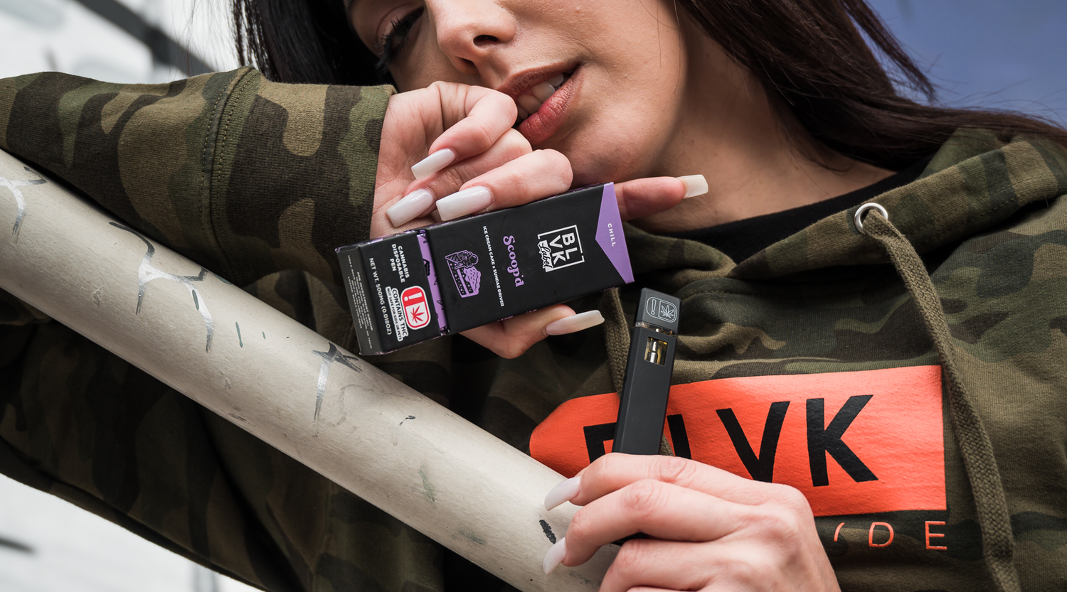 Woman holding the Scoop'd BLVK Label Disposable.