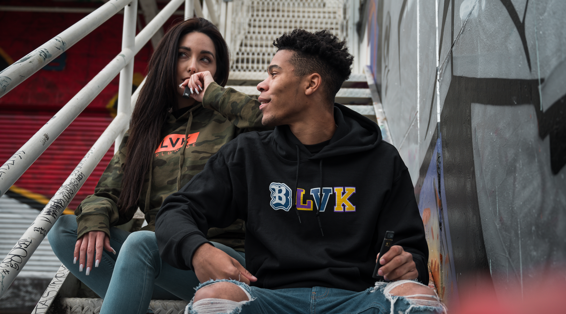 Two people sporting BLVK attire and smoking BLVK Label.